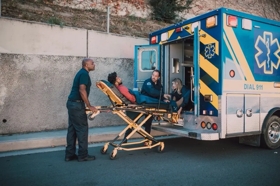 Paramedics beside an ambulance with a stretcher