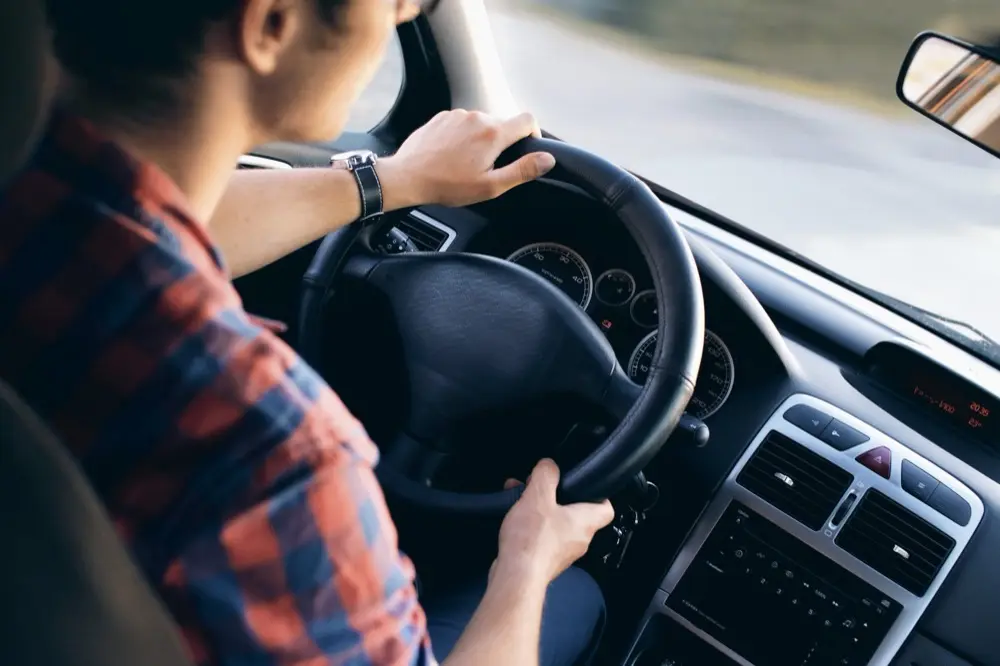 Driver holding a steering wheel